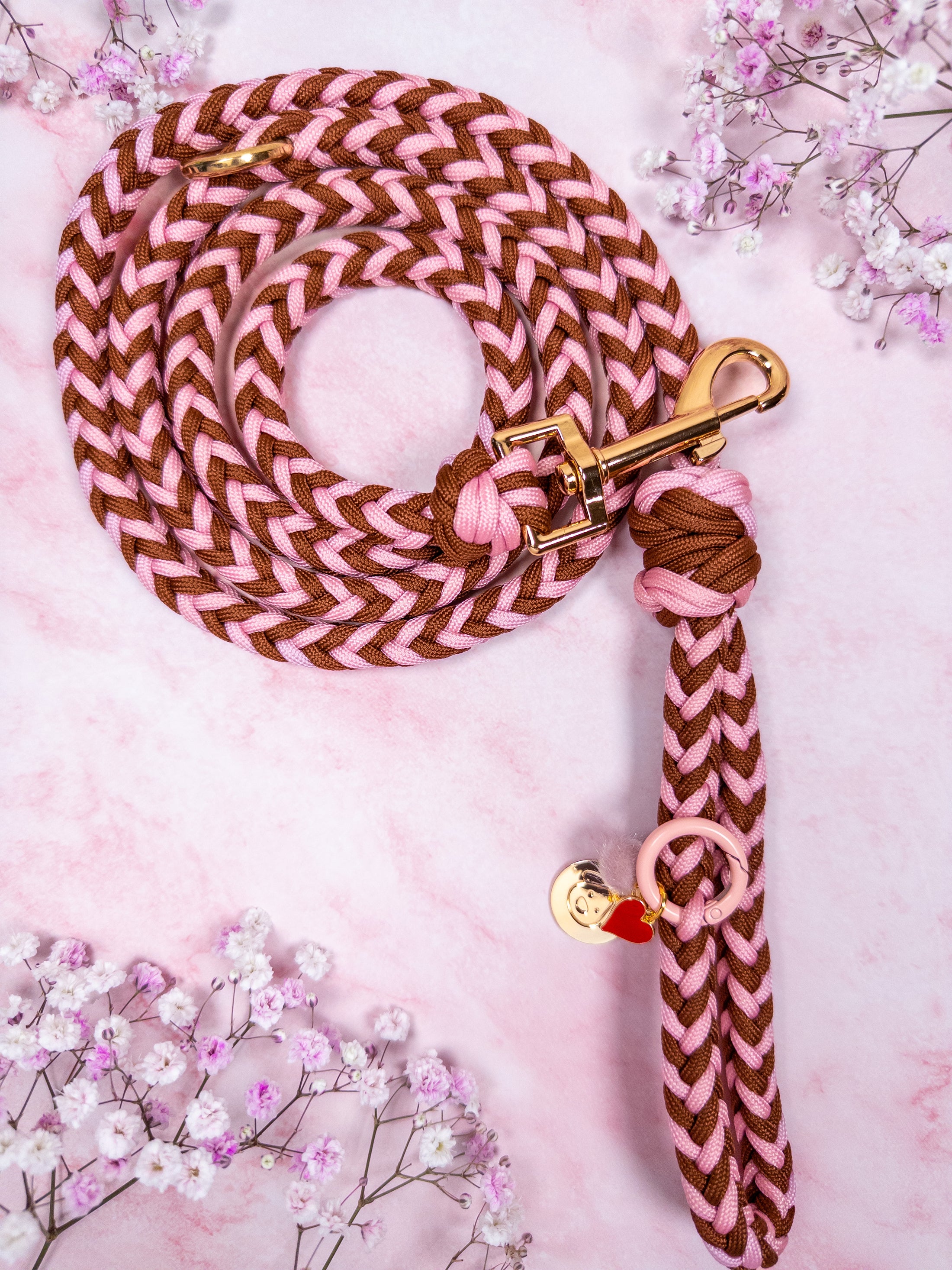 Hand-braided nylon dog leash in brown and soft pink.